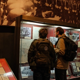 War Museum in Kyiv - visitors exploring historical documents and photographs inside the museum