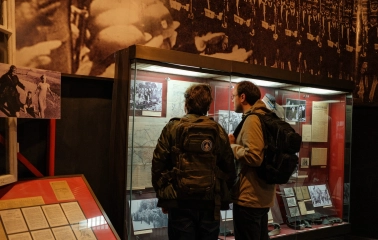 War Museum in Kyiv - visitors exploring historical documents and photographs inside the museum