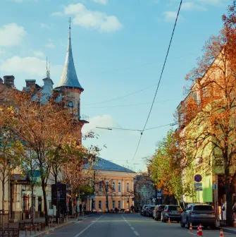 Yaroslaviv Val in Kyiv - cozy autumn street with red brick castle tower