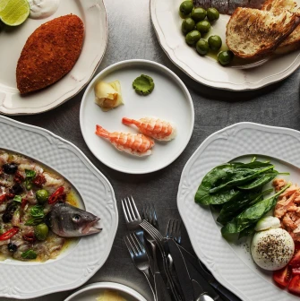 Fish Fetish - close-up view of a plated seafood dish with fish and fresh garnish