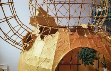 Restaurant Kytaiskyi Pryvit - large cat-shaped metal and paper sculpture with a small seating area inside