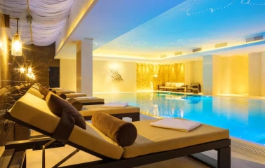 Swimming pool and relaxation area in the Hilton Kyiv spa with sun loungers