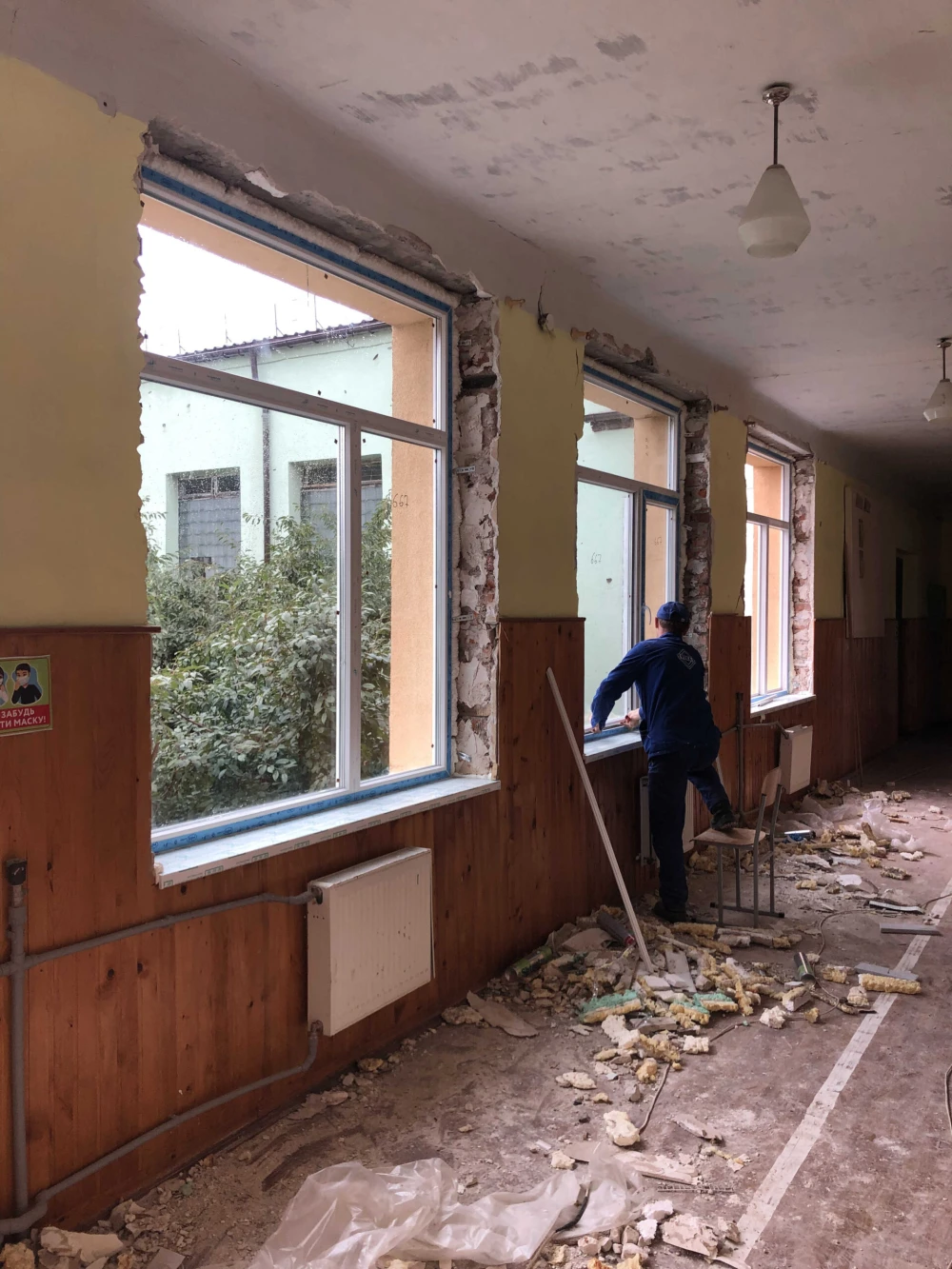 Volunteers repairing damaged school building during war in Kyiv