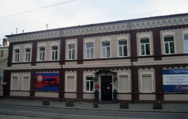 Muzei Suchasnoho Mystetstva in Kyiv - historic building facade combining maroon and beige brickwork with the museum signage near the entrance