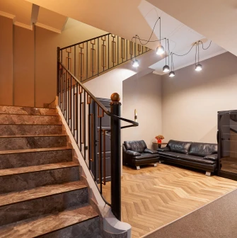 Staircase leading to the second floor of Hotel Classic with a cozy seating area