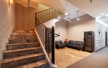Staircase leading to the second floor of Hotel Classic with a cozy seating area
