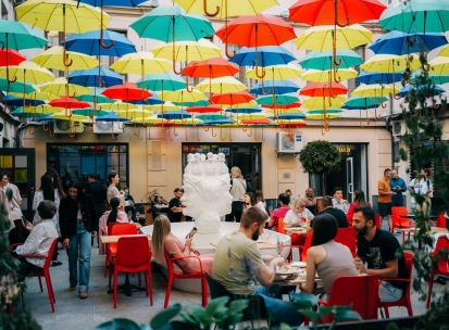 Restaurant Tisto, Syr i Titka Bella - courtyard seating under colorful suspended umbrellas