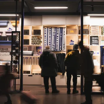 Zalizna Kramnytsia in Kyiv - a shining showcase of a souvenir shop filled with goods and silhouettes of customers