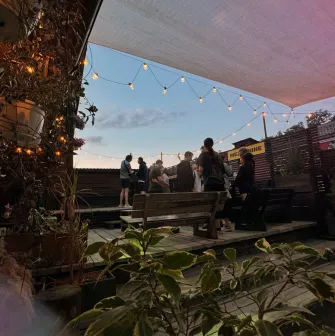 Vechirochka - outdoor terrace with string lights and guests