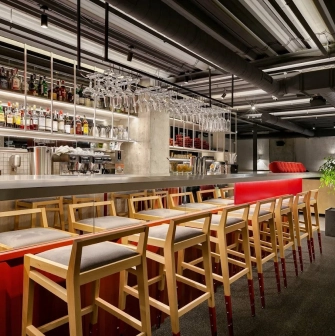 Fatum - modern bar counter with bottles and wooden stools