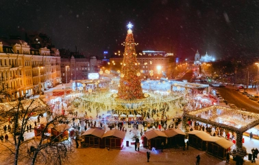 Sofiiska Square in Kyiv - large illuminated Christmas tree and festive market stalls at night