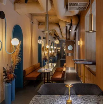 A cozy area for two at Zmist bar in Kyiv with a marble table and modern lighting