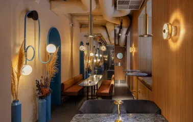 A cozy area for two at Zmist bar in Kyiv with a marble table and modern lighting