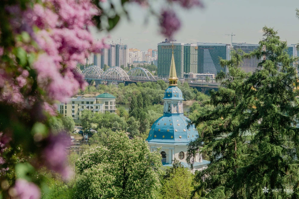 Spring landscape with blooming lilac and church in Kyiv