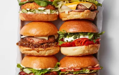 Six different burgers on paper at Holy Burger