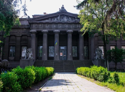 Natsionalnyi Khudozhnii Muzei Ukrainy in Kyiv - majestic dark grey classical facade with a Greek portico and lion sculptures guarding the entrance stairs