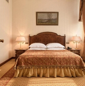 Cozy room with a king-size bed at the Premier Palace Hotel in Kyiv