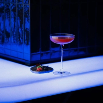 Sansara - close-up view of a unique cocktail served next to a small appetizer