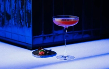 Sansara - close-up view of a unique cocktail served next to a small appetizer