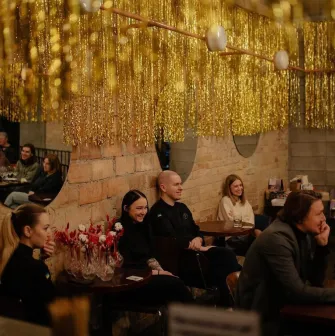 Restaurant Zigzag - interior with tinsel decorations a brick wall and seated guests