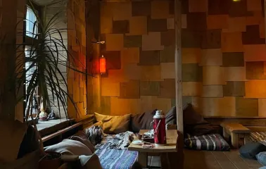 Chaguan in Kyiv - low seating area with floor cushions and hanging red lanterns