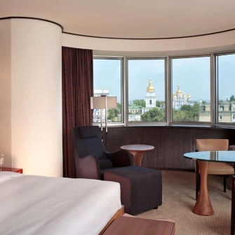 Room at Hyatt Regency Kyiv with panoramic views of St. Michael's Cathedral and a cozy seating area