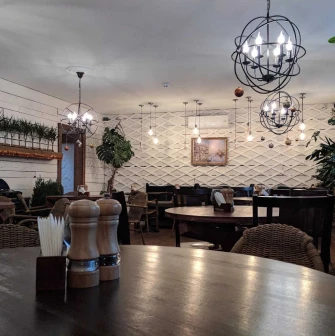 Cozy restaurant interior with wooden tables and decorative chandeliers