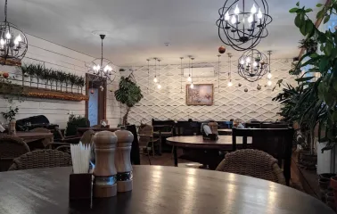 Cozy restaurant interior with wooden tables and decorative chandeliers
