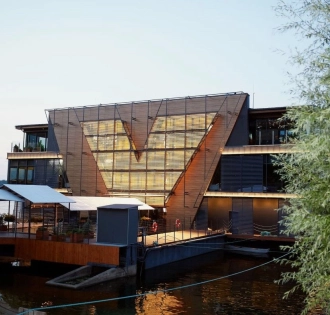 Restaurant Veranda on the river - tiered restaurant building facade near the water at sunset