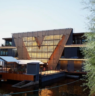 Restaurant Veranda on the river - tiered restaurant building facade near the water at sunset