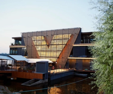 Restaurant Veranda on the river - tiered restaurant building facade near the water at sunset