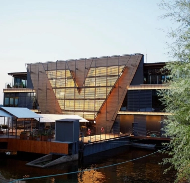 Restaurant Veranda on the river - tiered restaurant building facade near the water at sunset