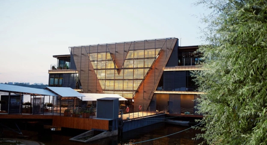 Restaurant Veranda on the river - tiered restaurant building facade near the water at sunset