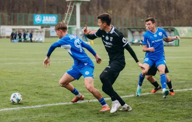 Футболісти в синій та чорній формі ведуть боротьбу за м'яч на полі Оболонь Арени