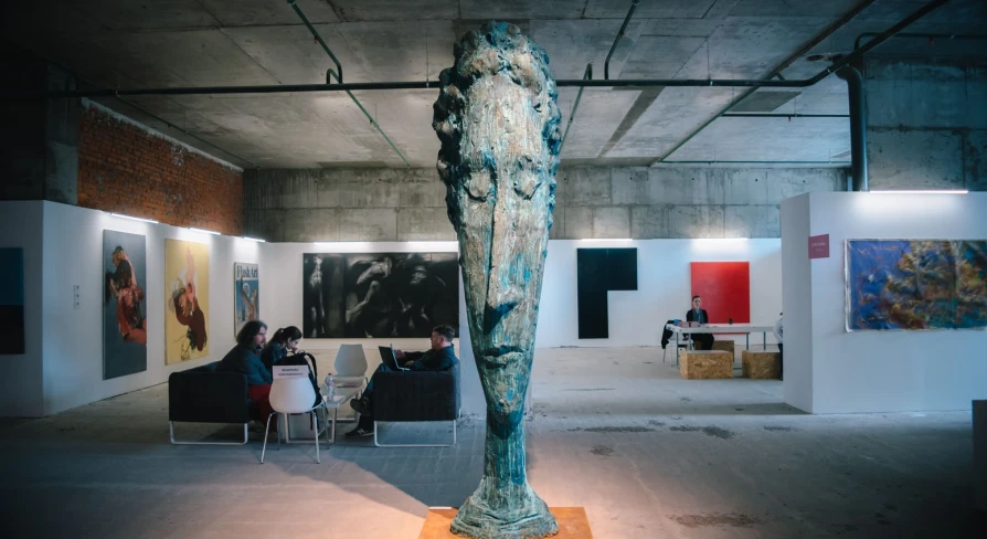 Large head sculpture in the M17 exhibition space in Kyiv