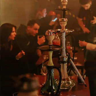Vugol na Arsenalnii - guests smoking hookah at lounge table