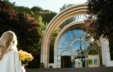 Kyiv Funicular - woman with flowers standing before the arched entrance