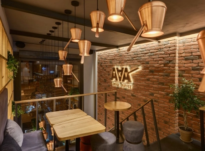 Takava in Kyiv - mezzanine seating with copper cezve lamps and brick wall logo