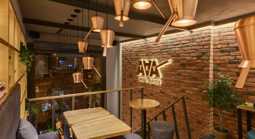 Takava in Kyiv - mezzanine seating with copper cezve lamps and brick wall logo