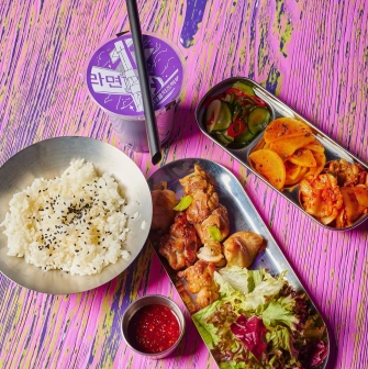 Street Kim - korean chicken rice set with side dishes on colorful table
