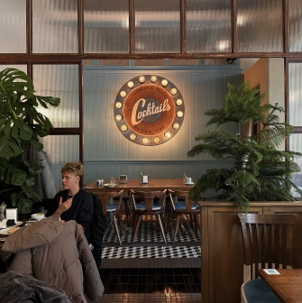 Milk Bar - vibrant interior featuring a neon sign and modern, stylish furniture