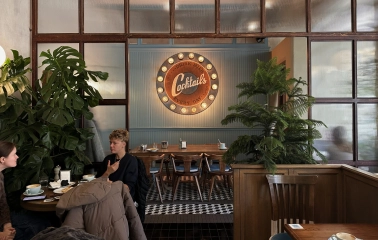 Milk Bar - vibrant interior featuring a neon sign and modern, stylish furniture
