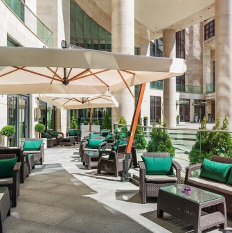 Hilton Kyiv - comfortable outdoor terrace seating area on a sunny day