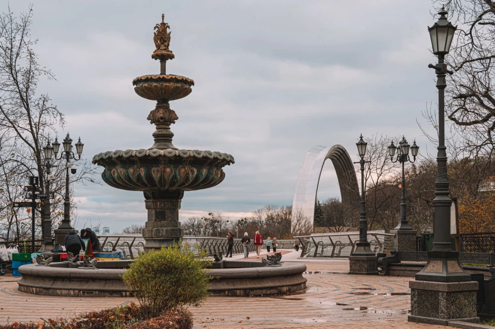 Glass Bridge in Kyiv - fountain on Volodymyr Hill with pedestrians walking across the bridge