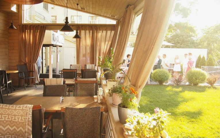 Restaurant Very Well Cafe - outdoor dining terrace featuring modern tables chairs and decorative plants