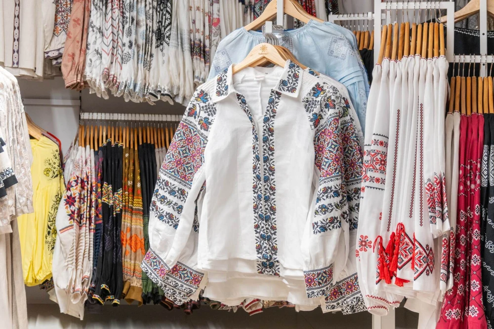 A close-up of vyshyvankas on hangers at Folkmart store in Kyiv