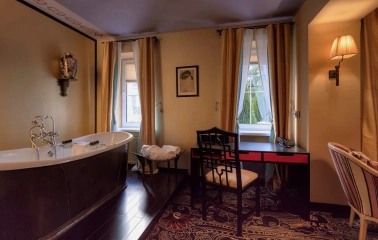 Vozdvyzhenskyi in Kyiv - bathroom with freestanding tub and black desk by window