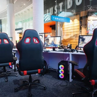 Ocean Plaza in Kyiv - modern esports gaming zone inside the mall equipped with professional black and red chairs and computers with neon RGB lighting