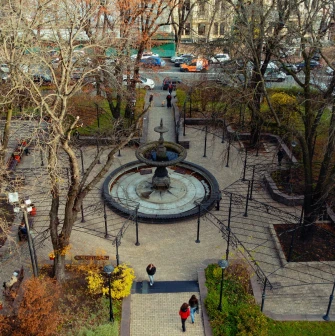 Golden Gate in Kyiv - view through the gate towards a small square with a fountain and surrounding trees