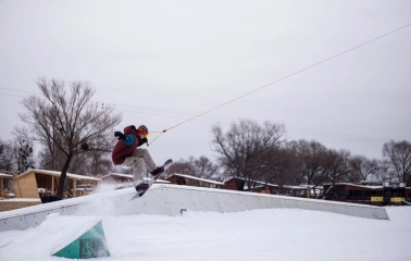 X-Park in Kyiv - snowboarder performing a high jump trick over a ramp